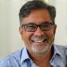 Portrait photo of Raj Mehta smiling.